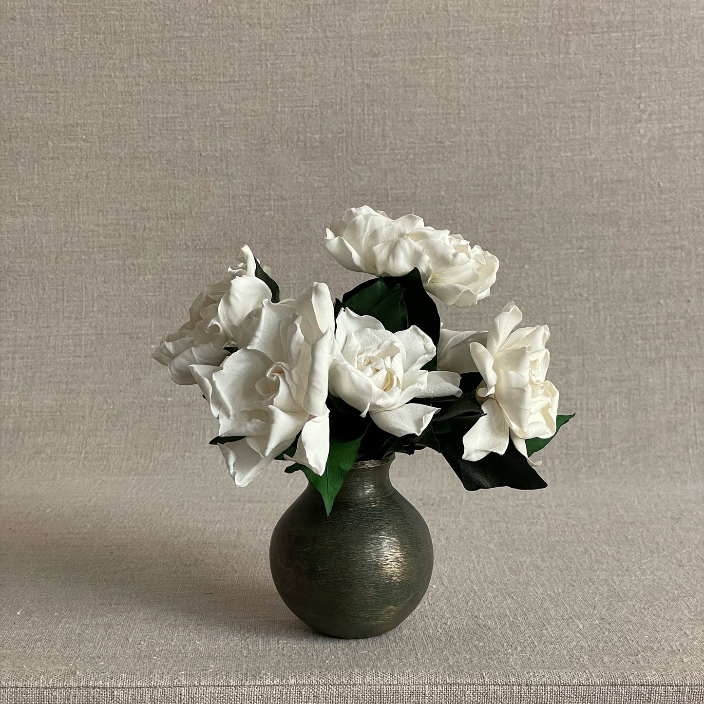 Gardenia Nosegay featuring preserved gardenia blooms in a heavy, hand-cast bronze vase