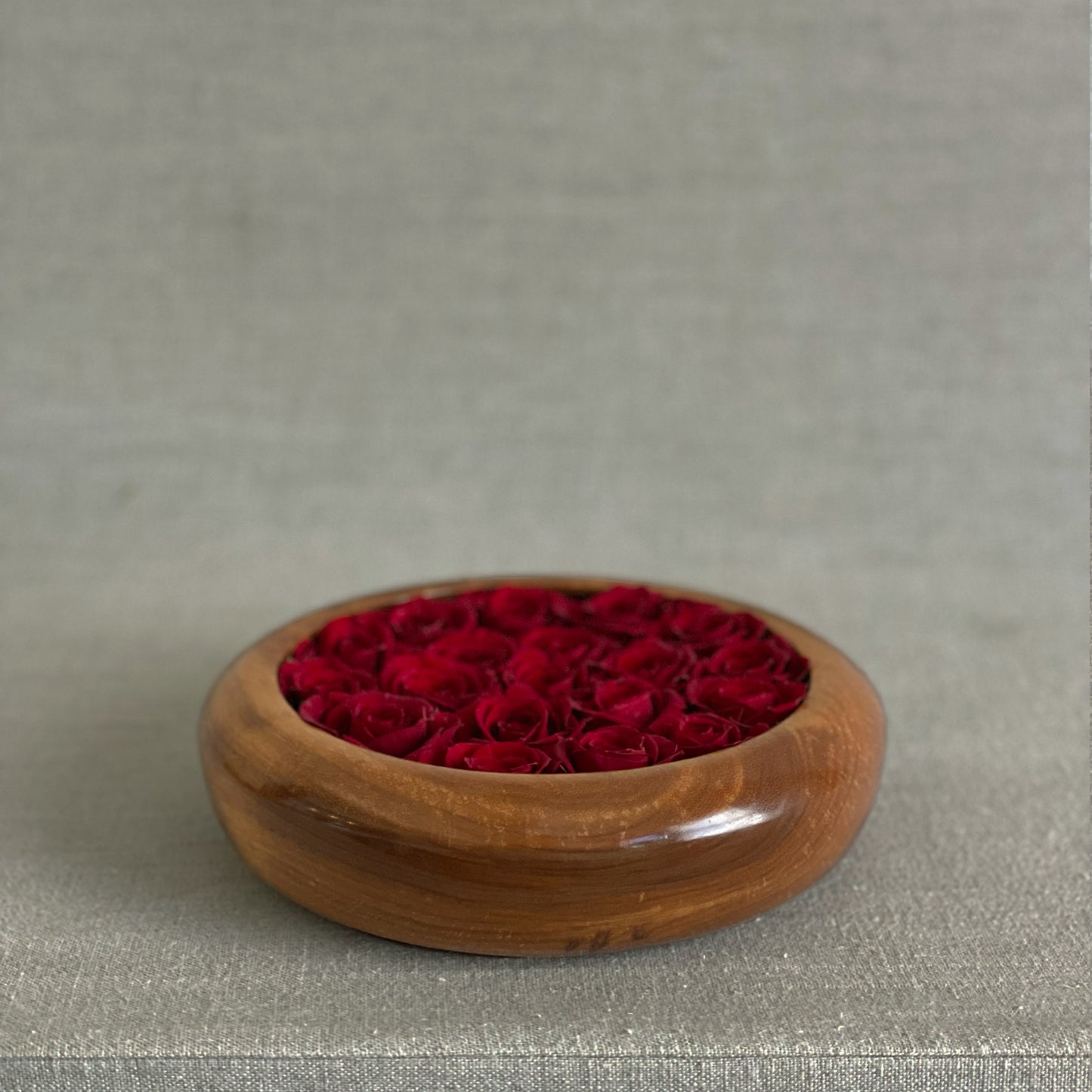 Unique hand-turned wooden bowls with preserved red roses for a lasting home accent.