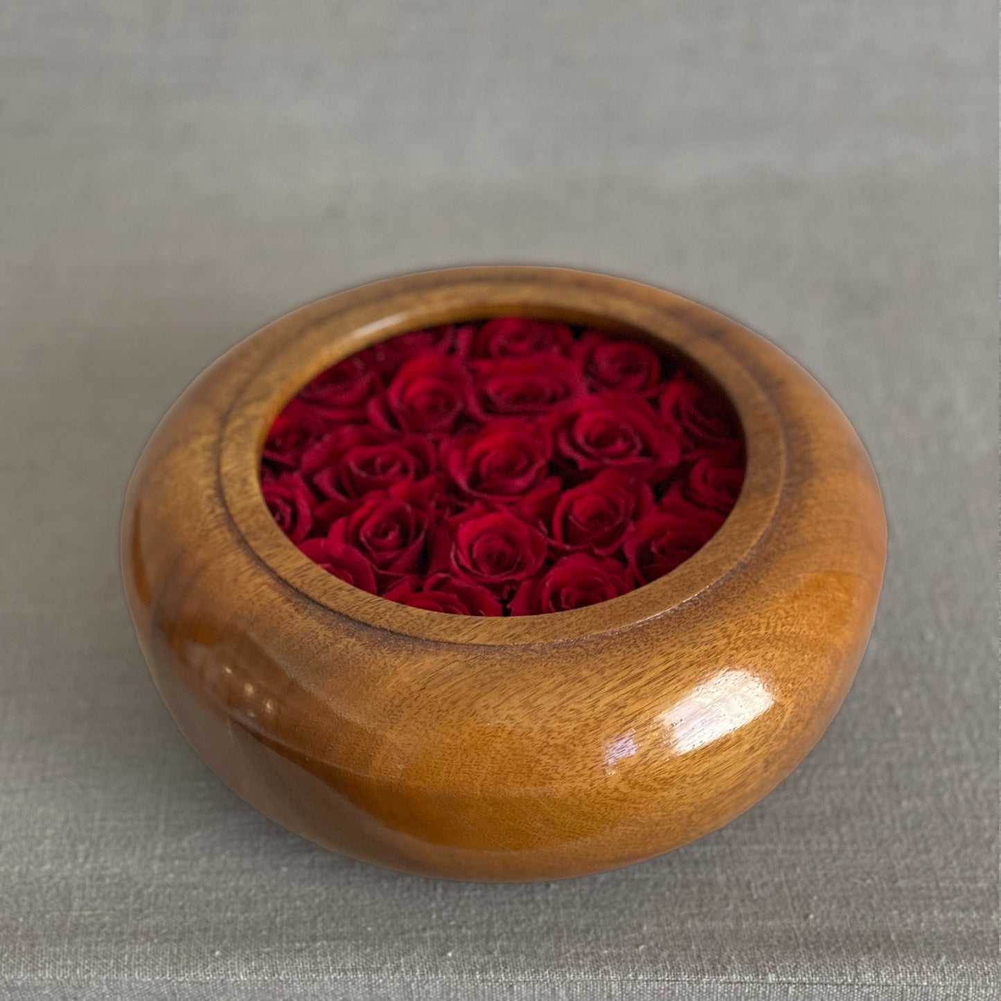 Unique hand-turned wooden bowls with preserved red roses for a lasting home accent.