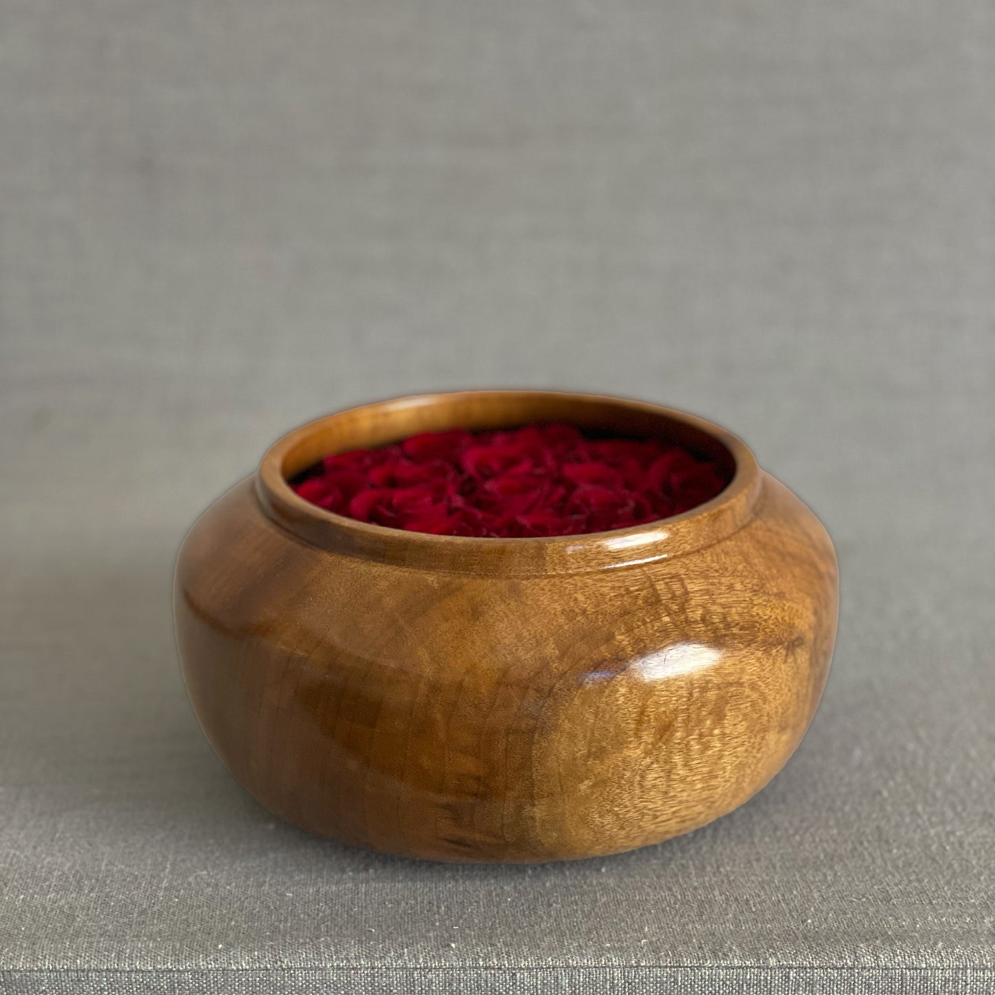 Unique hand-turned wooden bowls with preserved red roses for a lasting home accent.