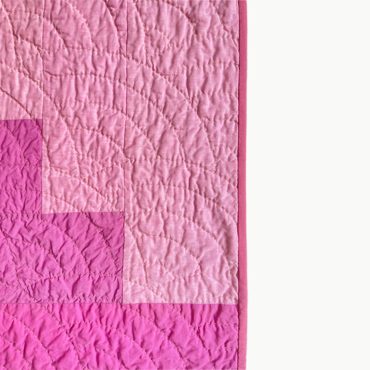 Close-up of the 'Pokeberry' quilt by Los Angeles Floral Company, showcasing the hand-stitched Baptist Fan pattern and vivid color palette.