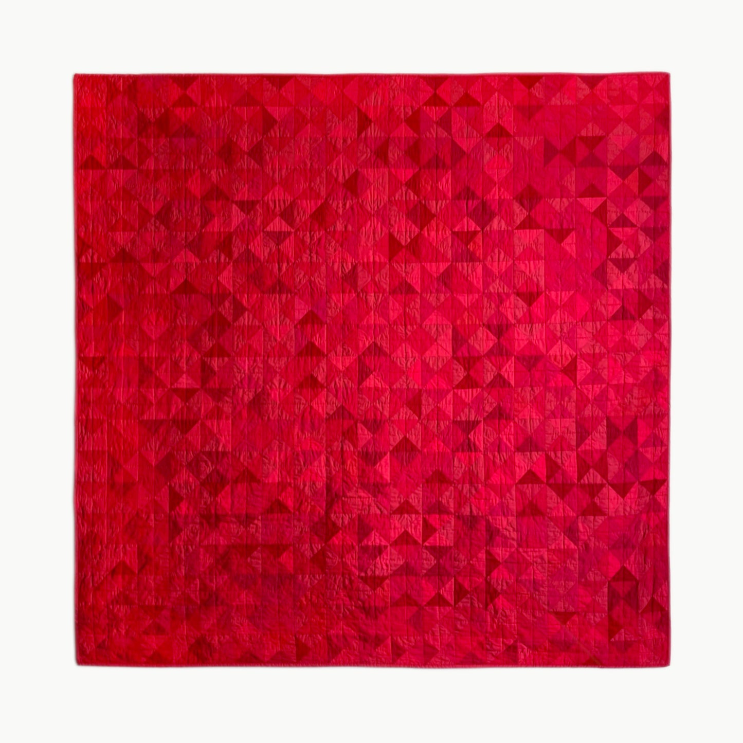 Hand-stitched R.A.E.’s throw-size quilt by Los Angeles Floral Company, featuring a vibrant red geometric pattern.