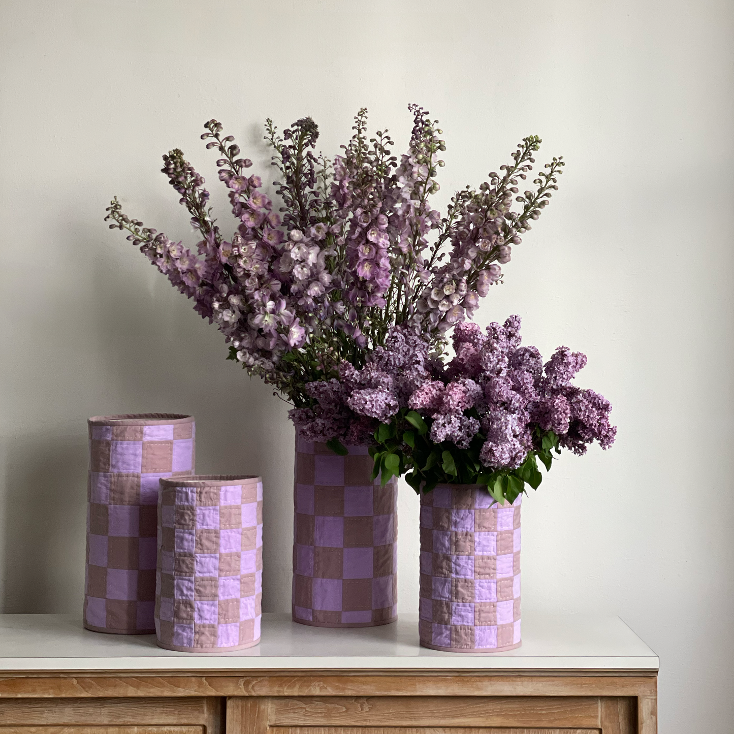 Lavender Lilac Quilt Vases styled with lilac and larkspur blooms, surrounded by additional small vases.