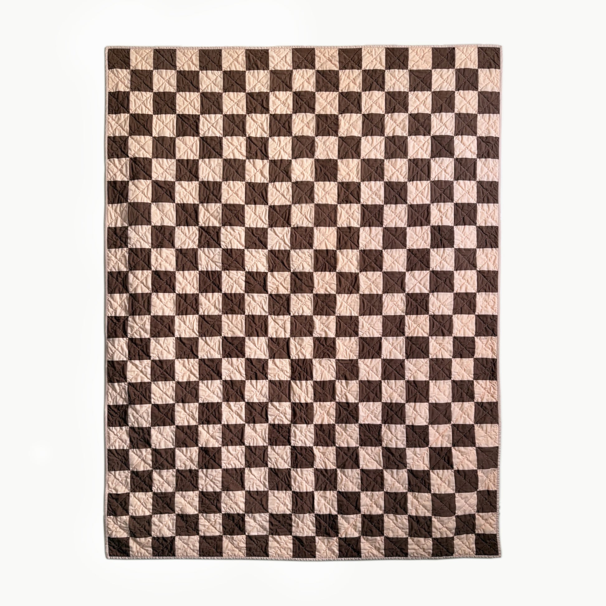 Full view of peach and brown checkerboard hand-quilted Twin quilt inspired by Nat Love’s Deadwood victory.