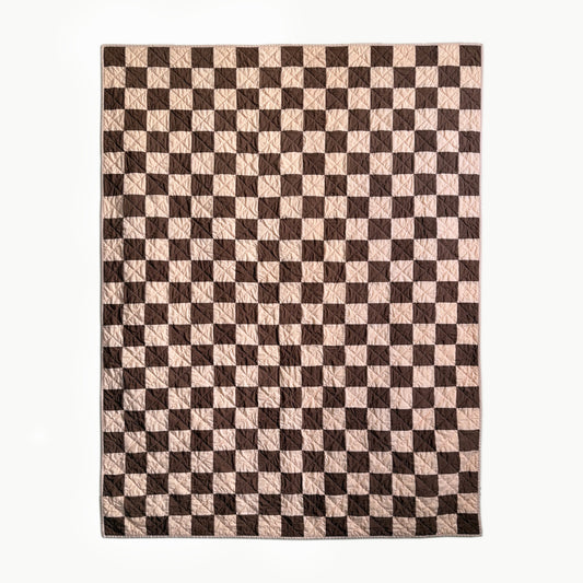 Full view of peach and brown checkerboard hand-quilted Twin quilt inspired by Nat Love’s Deadwood victory.