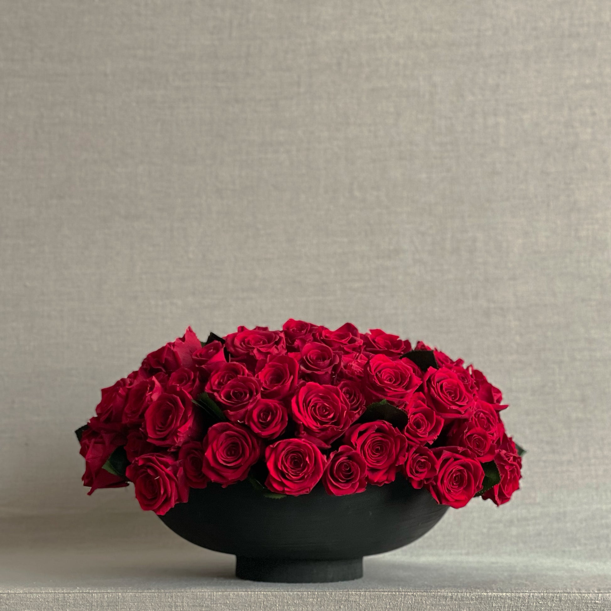 Forever Romance preserved red rose arrangement in a modern black footed bowl.