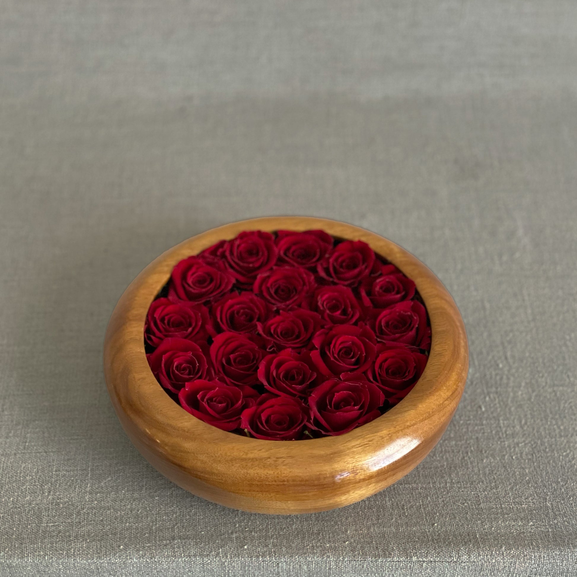 Minimalist preserved floral arrangements in artisan wooden bowls from the Hearts Honed Collection.