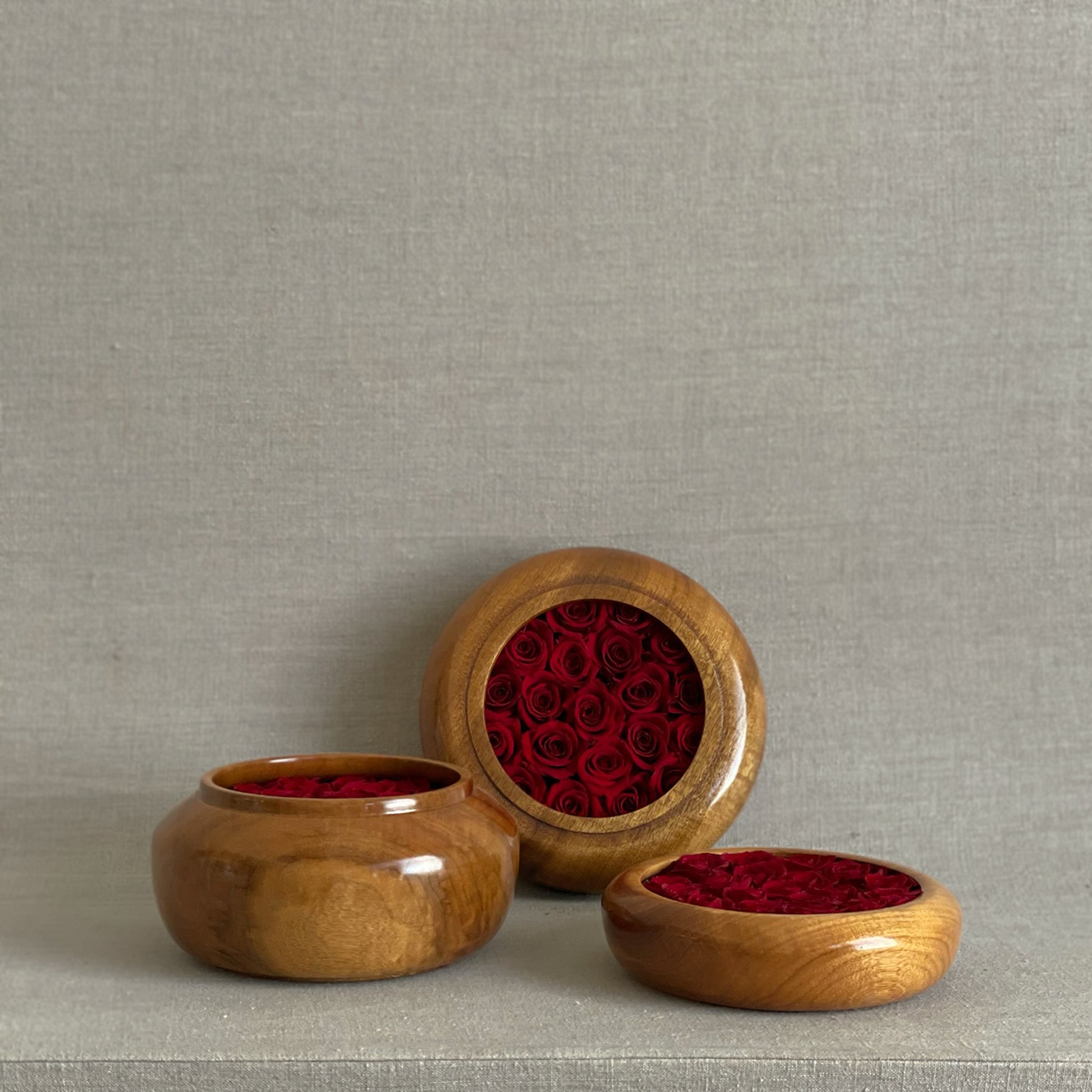Hearts Honed Collection featuring preserved red roses arranged in hand-turned wooden bowls