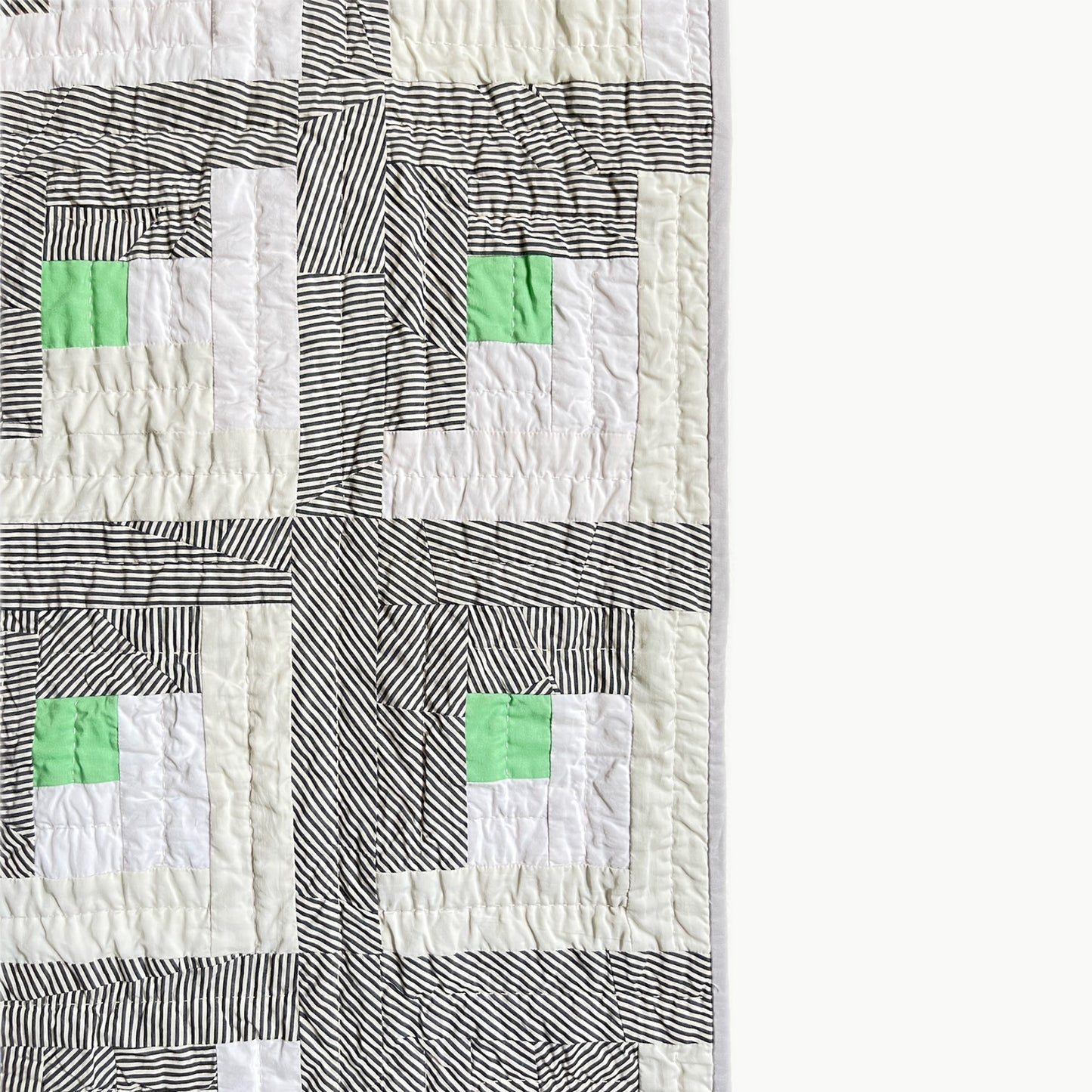 Close-up of the alternating stripe directions in the log cabin block design of the ‘1925’ quilt by Los Angeles Floral Company, showcasing Sashiko-style hand-stitching.