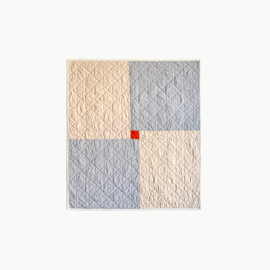 Hand-stitched ‘Baby Chan’ quilt by Los Angeles Floral Company, featuring soft pastels with a pop of red and Sashiko-style thread.