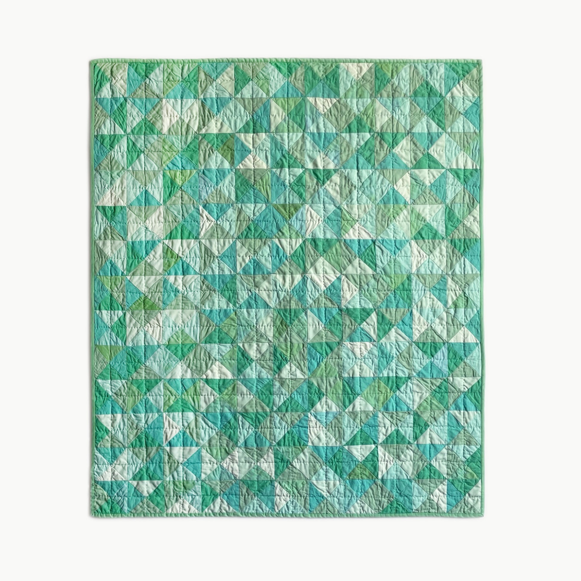 Hand-stitched ‘Hisui [Jade]’ crib-size quilt by Los Angeles Floral Company, featuring a soft green geometric pattern inspired by jadeite glass.