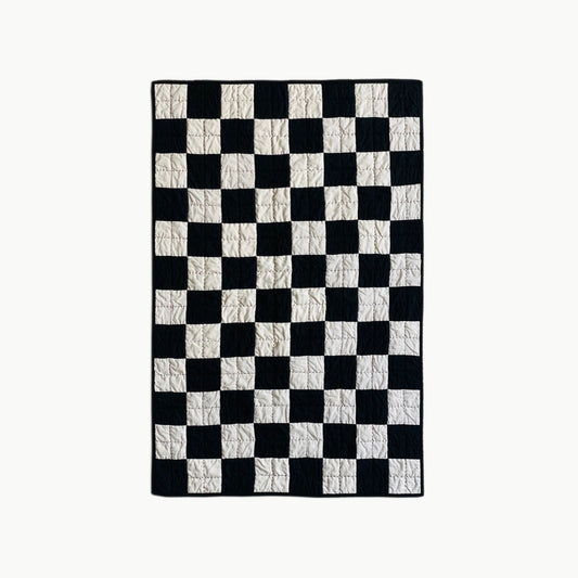 Hand-stitched ‘Hollywood Baby’ quilt by Los Angeles Floral Company, featuring a classic black and white checkerboard pattern.