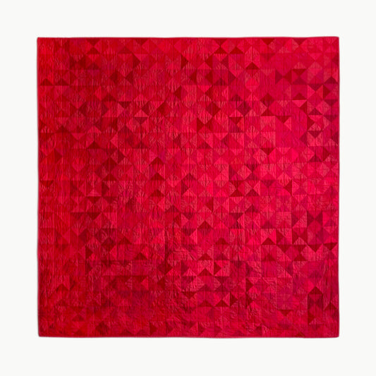 Hand-stitched R.A.E.’s throw-size quilt by Los Angeles Floral Company, featuring a vibrant red geometric pattern.