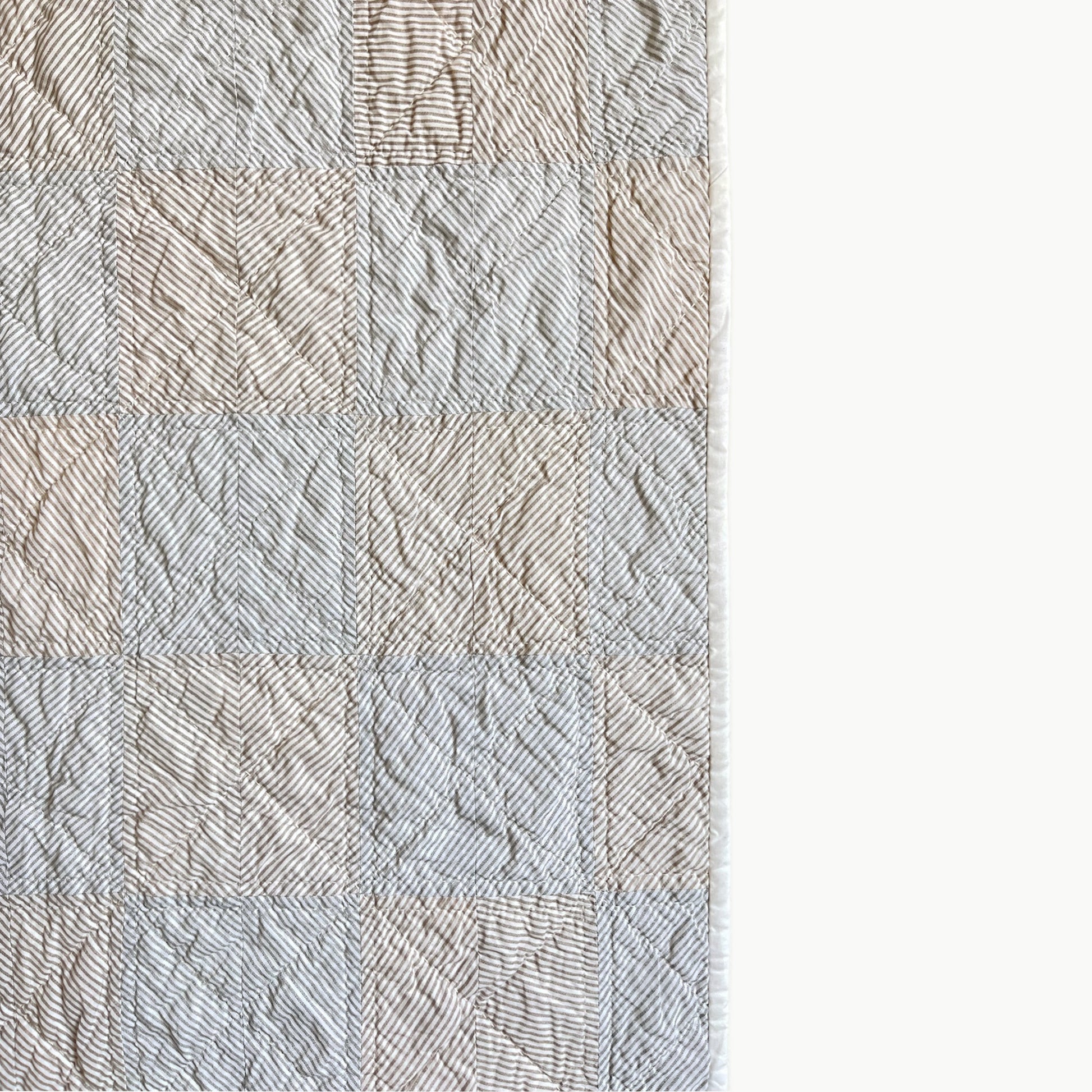 Close-up of the stripes in the ‘Stripe Study 2’ quilt by Los Angeles Floral Company, showcasing hand-stitched Sashiko-style quilting.