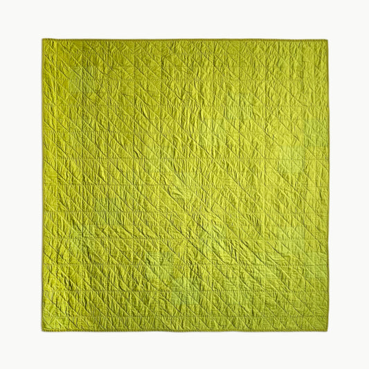 Hand-stitched Wakakusa throw-size quilt by Los Angeles Floral Company, featuring vibrant green hues inspired by young grass.