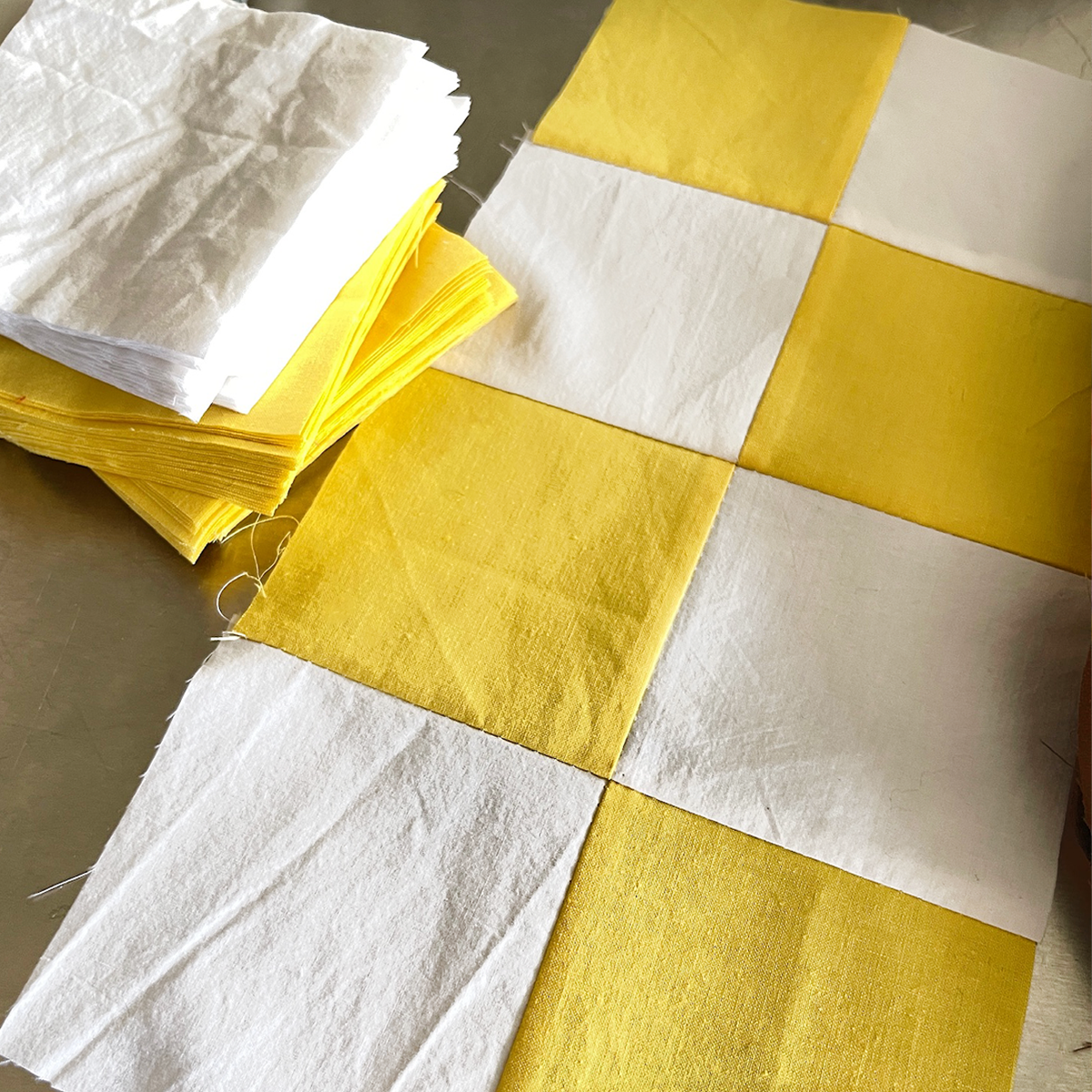 Yellow and white quilt squares in progress, capturing the handcrafted quilting process at Los Angeles Floral Company.