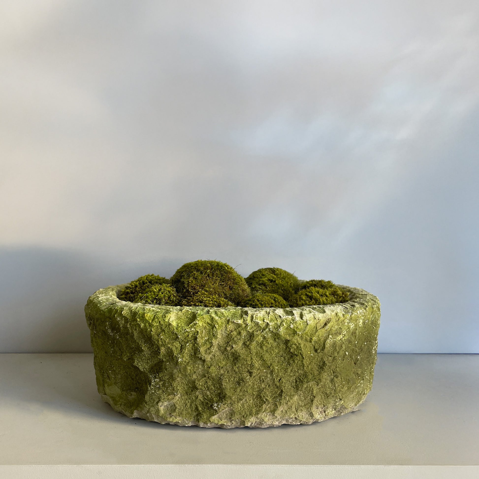 Another angle of Large Moss Stone, hand-chiseled limestone with aged patina and pillow moss.