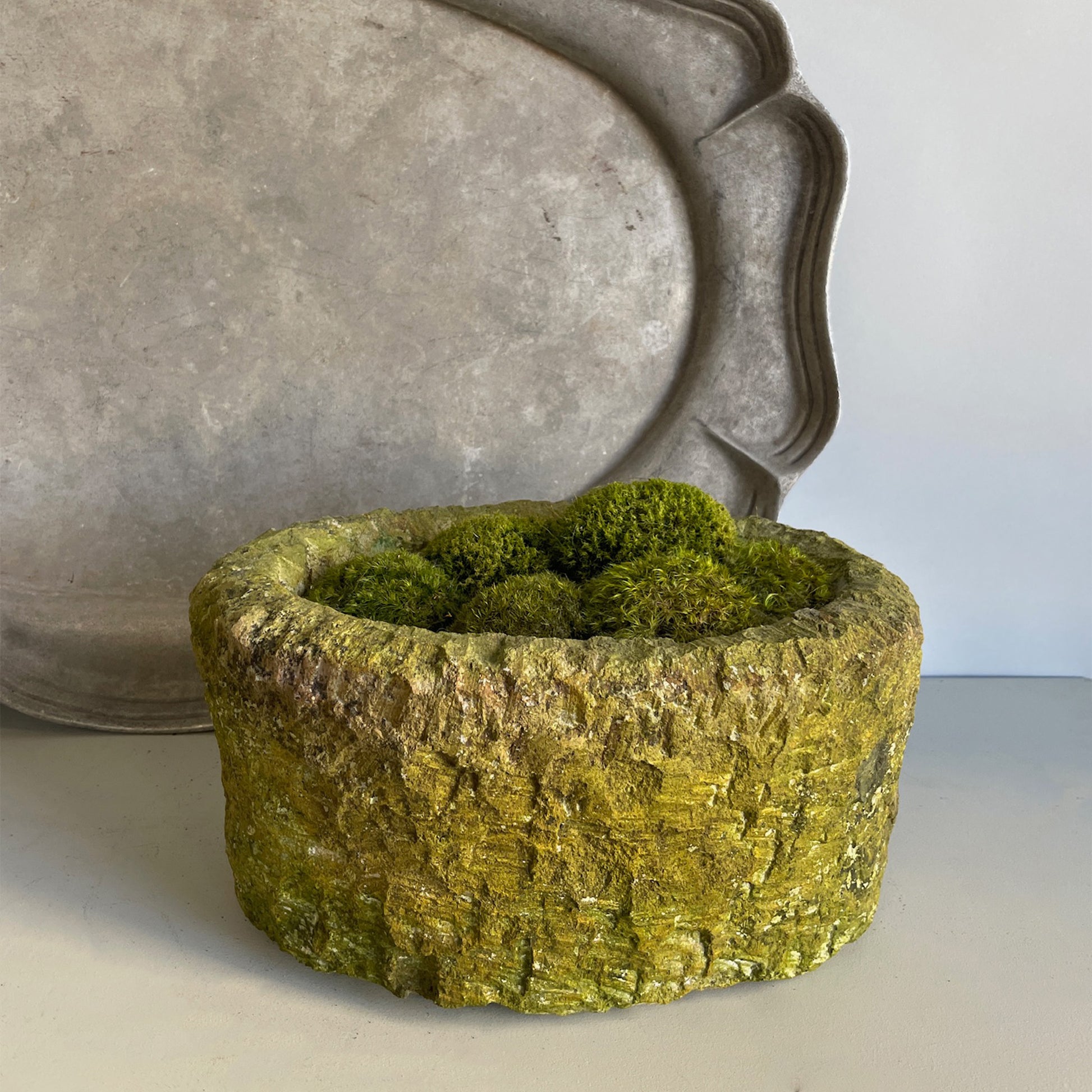 Small Moss Stone  featuring hand-chiseled limestone and lush green moss.