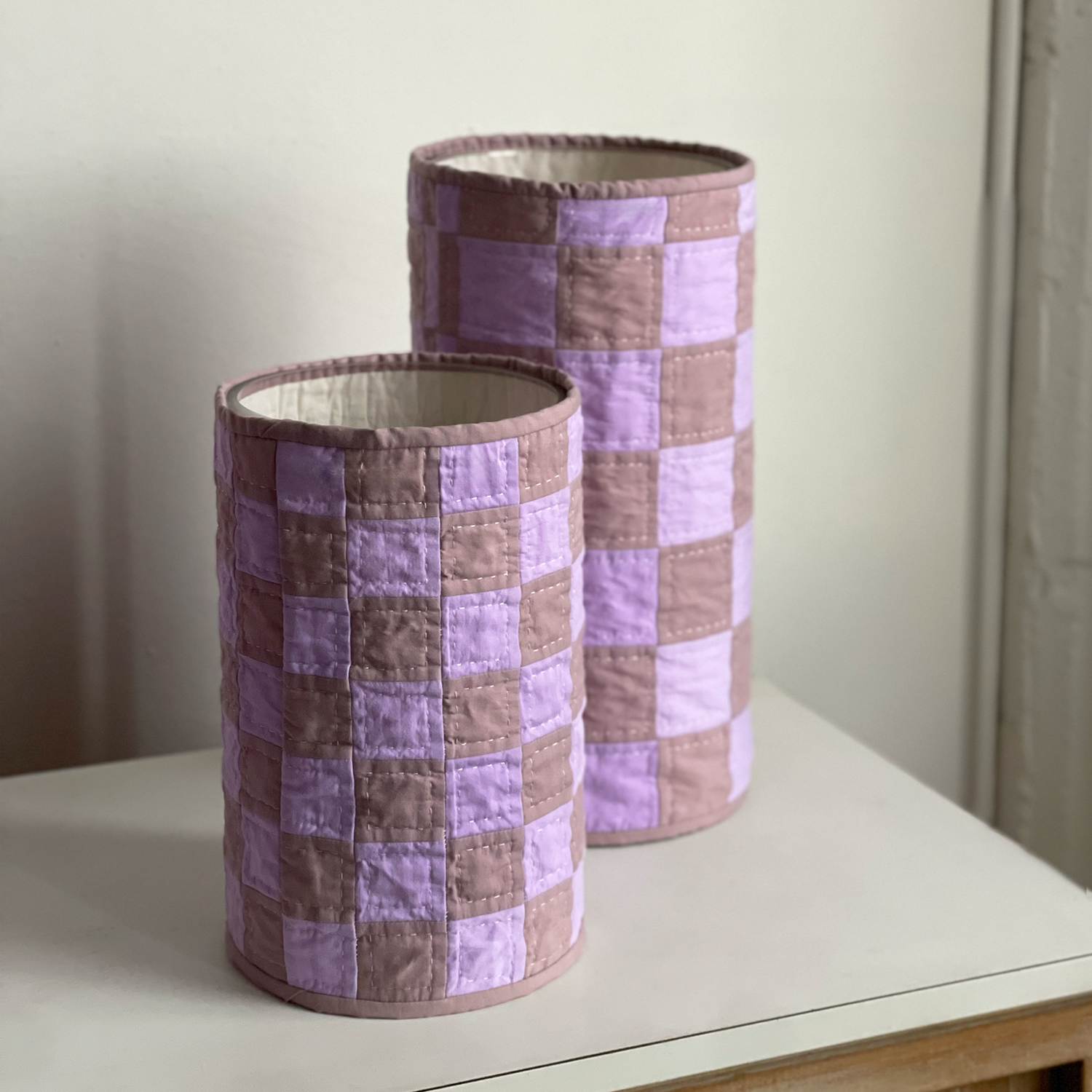 Angled view of quilt vases in Lavender Lilac Patchwork, showing open glass interior and hand-stitched detail.