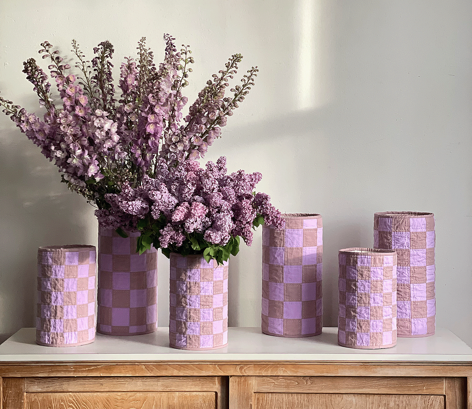Lavender Lilac Quilt Vases styled in a group arrangement with fresh lilac and Larkspur flowers.